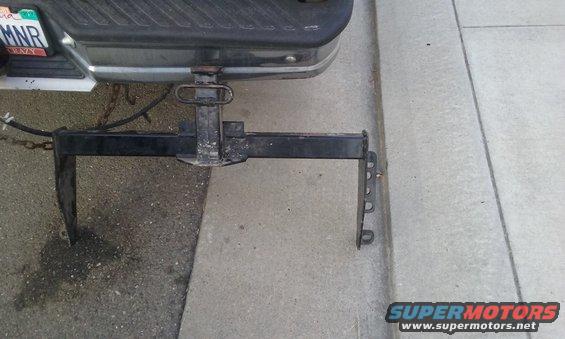 Rear bumper of a truck with a trailer hitch and chains attached