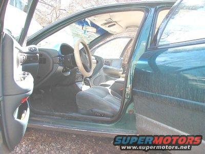 1995 Dodge Intrepid interior, driver's side door open, showing dashboard, steering wheel, and seats