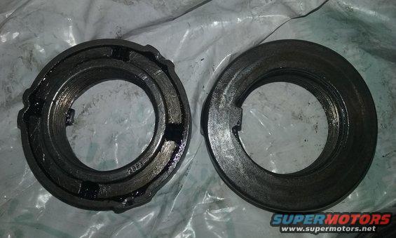 two metal bearing lock nuts, one with visible part number 2823