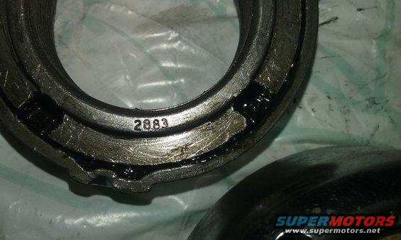 Close-up of a metal bearing part with '2883' stamped on it