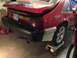 1983 Ford Mustang - Rear view of a red car, possibly undergoing repairs or modification.