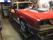 1983 Ford Mustang - This 1983 Ford Mustang coupe is shown in a garage, possibly undergoing repairs or restoration.