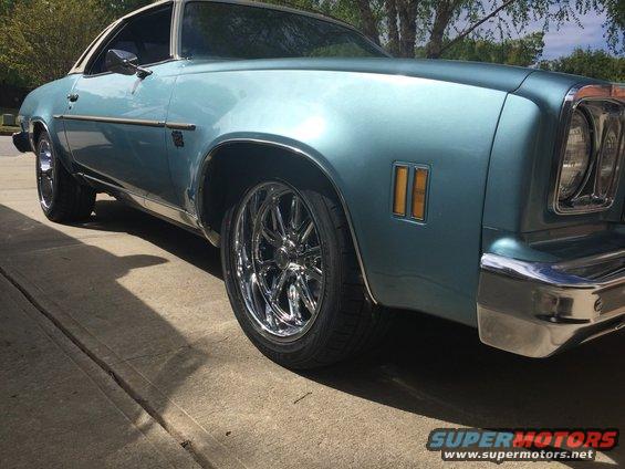 Light blue 1975 Chevrolet Chevelle coupe with chrome wheels, 3q-front view
