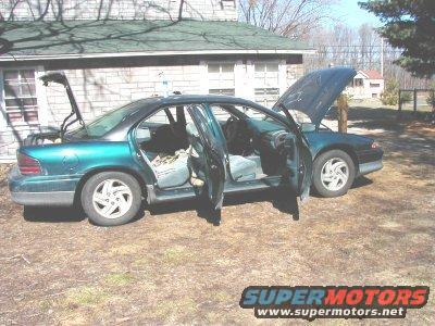 Green 1995 Dodge Intrepid with doors and hood open