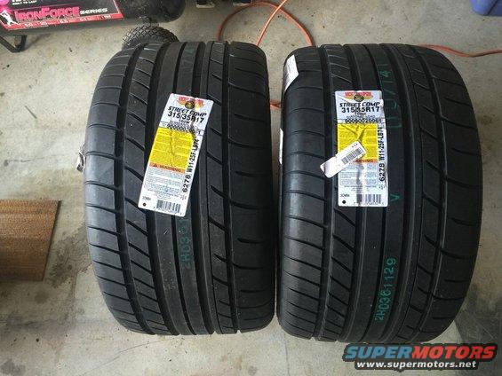 Two new Nitto Street Comp 315/35R17 tires with yellow labels