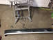 1983 Ford Mustang - Car bumper and Dremel tool on a sawhorse, likely in a garage or workshop setting.