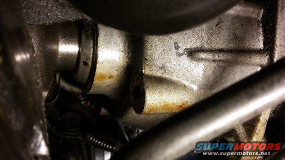 Close-up of a metal engine part with some rust and grime