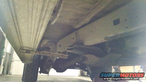 The aftermarket running boards were installed wrong (to frame AND body), and this side isn't even attached to its brace (which is barely attached to the frame).