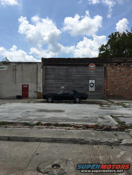 Black 1967 Mercury Cougar parked outside a building with a Gulf sign