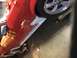 1983 Ford Mustang - Side view of a red car's side skirt 'MUSTANG GT' text and a silver wheel.