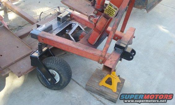 Trailer hitch assembly with jack stand and small wheel
