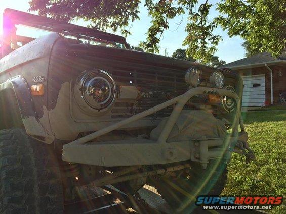 Tan Ford Bronco with aftermarket bumper and winch, front view