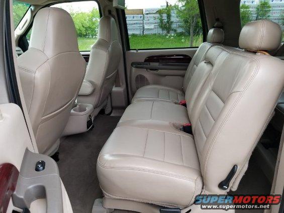 2003 Ford Excursion interior showing beige leather seats and door panel