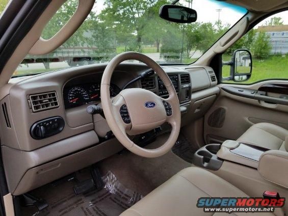 Dashboard and steering wheel of a Ford truck. Shows air vents, instrument cluster, and center console