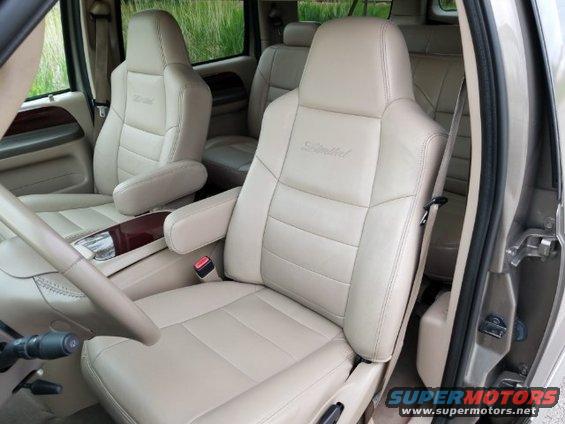 Tan leather captain's chairs with 'Limited' embroidery in a 2003 Ford Excursion