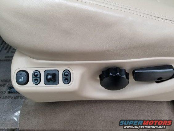 Beige leather seat controls with buttons for heating and power adjustment
