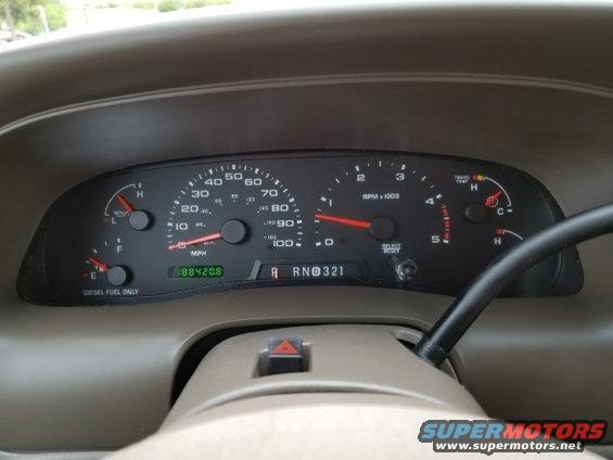 2003 Ford Excursion dashboard with speedometer, tachometer, fuel gauge, and odometer showing 188420.8
