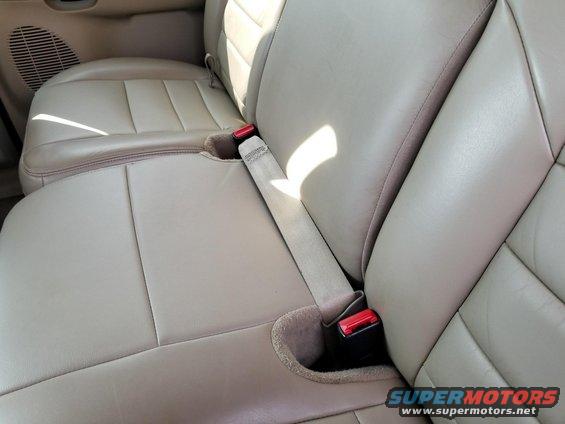 2003 Ford Excursion interior showing tan leather seats and seatbelts