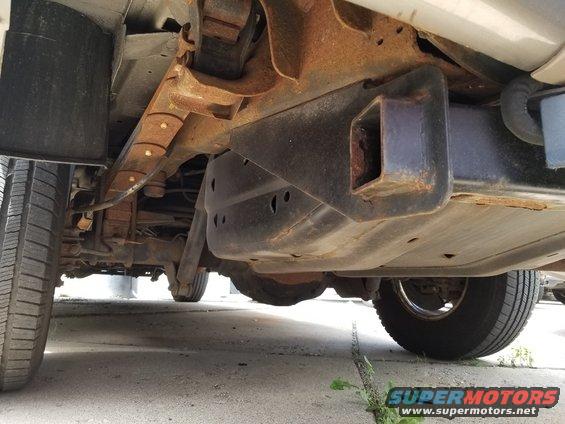 Underside view of a 2003 Ford Excursion showing the rear suspension, leaf springs, and trailer hitch