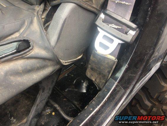Close-up of a modified Jeep interior, showing custom rocker panel work