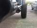 1995 Jeep YJ - A Jeep with prominent "Jeep" lettering on its side is shown with a large off-road tire.