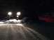 1995 Jeep YJ - A Jeep Wrangler navigates a snowy path at night, its headlights cutting through the darkness.