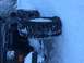 1995 Jeep YJ - A Jeep Wrangler is partially buried in snow, with two spare tires visible on its side.