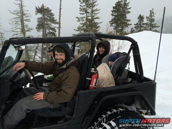 1995 Jeep YJ with people in the snow, driver smiling