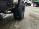 1995 Jeep YJ - Multiple Jeeps parked on a snowy, icy surface, focusing on the rear tire of one vehicle.