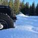 1995 Jeep YJ - A black 1995 Jeep YJ is partially submerged in snow, with another white Jeep visible in the distance.