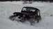 1995 Jeep YJ - A black Jeep Wrangler navigates through a snowy landscape, kicking up snow as it goes.