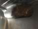 1978 Ford Bronco - Close-up view of the underside of a vehicle component, showing its shape and texture.