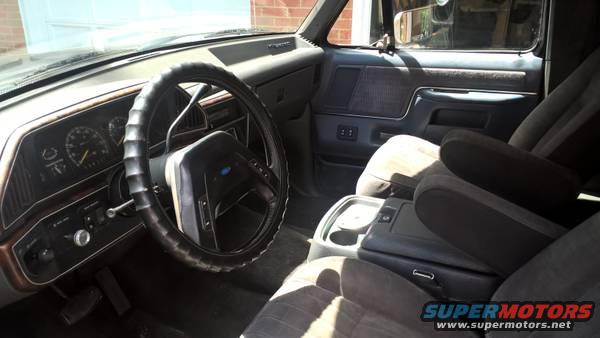 1990 Ford Bronco interior showing dashboard, steering wheel, and front seats