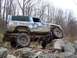 1978 Ford Bronco - Muddy 1978 Ford Bronco navigates a rocky obstacle course during an off-road excursion.