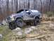 1978 Ford Bronco - A 1978 Ford Bronco navigates a rocky trail in a forest, its off-road capabilities.