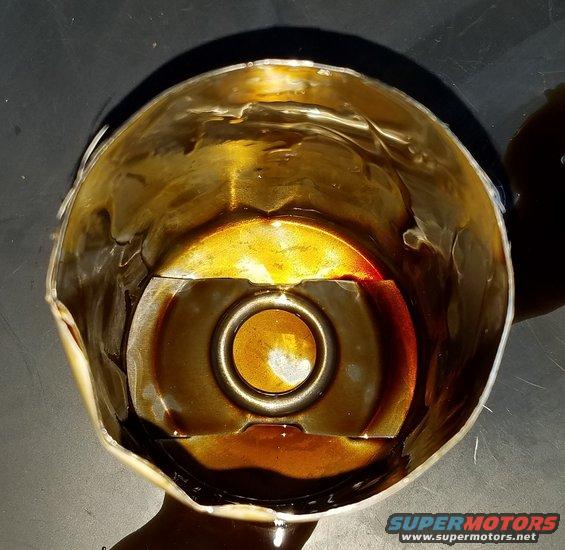 Used oil filter with dark oil residue inside