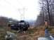 1978 Ford Bronco - Two SUVs navigate a rocky, wooded terrain under a large power line tower.