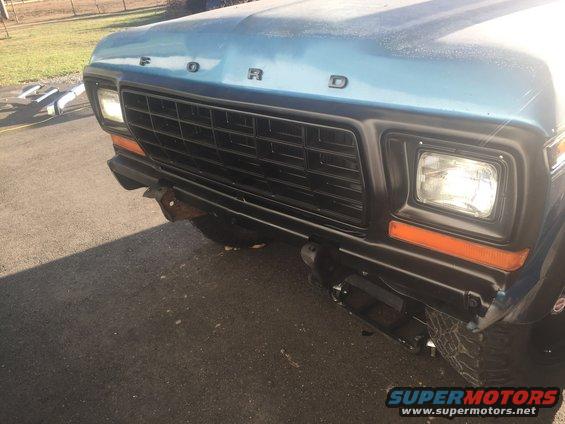 Blue 1978 Ford Bronco front grille and bumper with orange turn signals