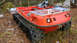 1986 Argo Response - This amphibious tracked vehicle is parked in a wooded area with fallen leaves on the ground.