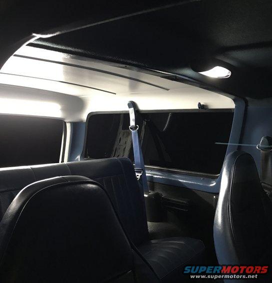Interior view of a vehicle showing blue seats and headliner
