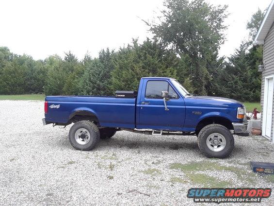 Blue 1996 Ford F-350 pickup truck, side view