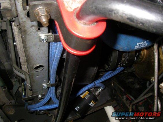 Blue braided hoses and black filter in engine bay