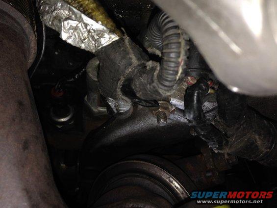 Close-up of engine wiring and exhaust pipe connections