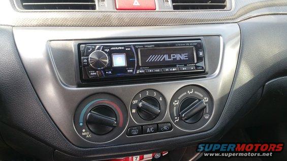 Car dashboard with Alpine stereo and climate controls