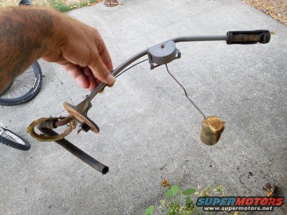 Hand holding a fuel sending unit with a float