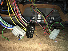 Wiring connectors and bundles of colorful wires under the dashboard