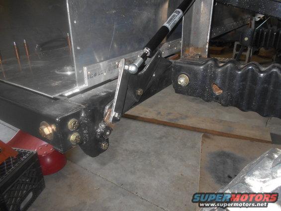 Vehicle frame part with gas strut and mounting hardware