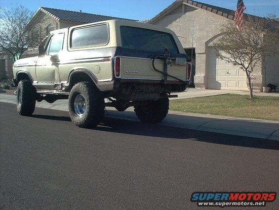1979 Ford Bronco lifted with large tires, parked on a suburban street