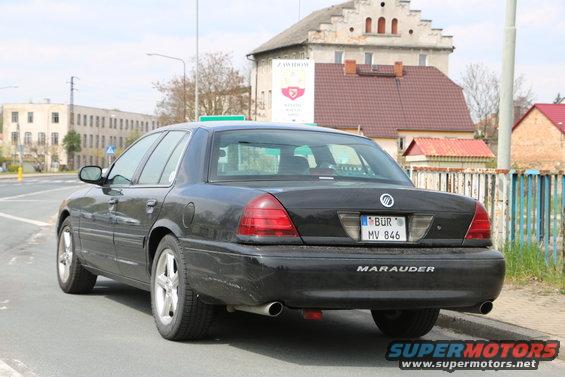 Black 2003 Mercury Marauder sedan, rear 3/4 view, parked on street