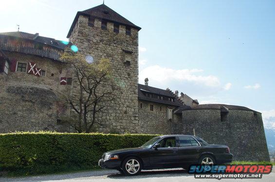Black 2003 Mercury Marauder parked by a castle tower